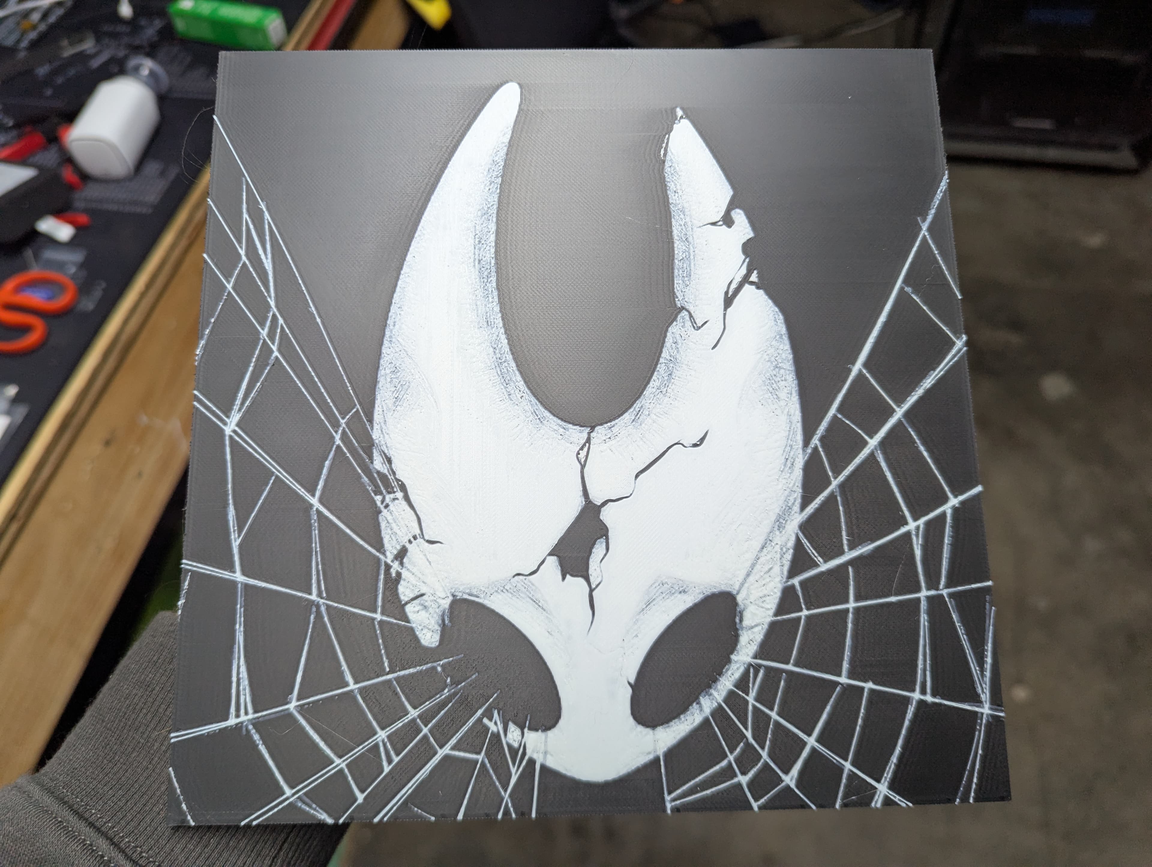 Filament print of a fan-art hornet character mask, held in hand