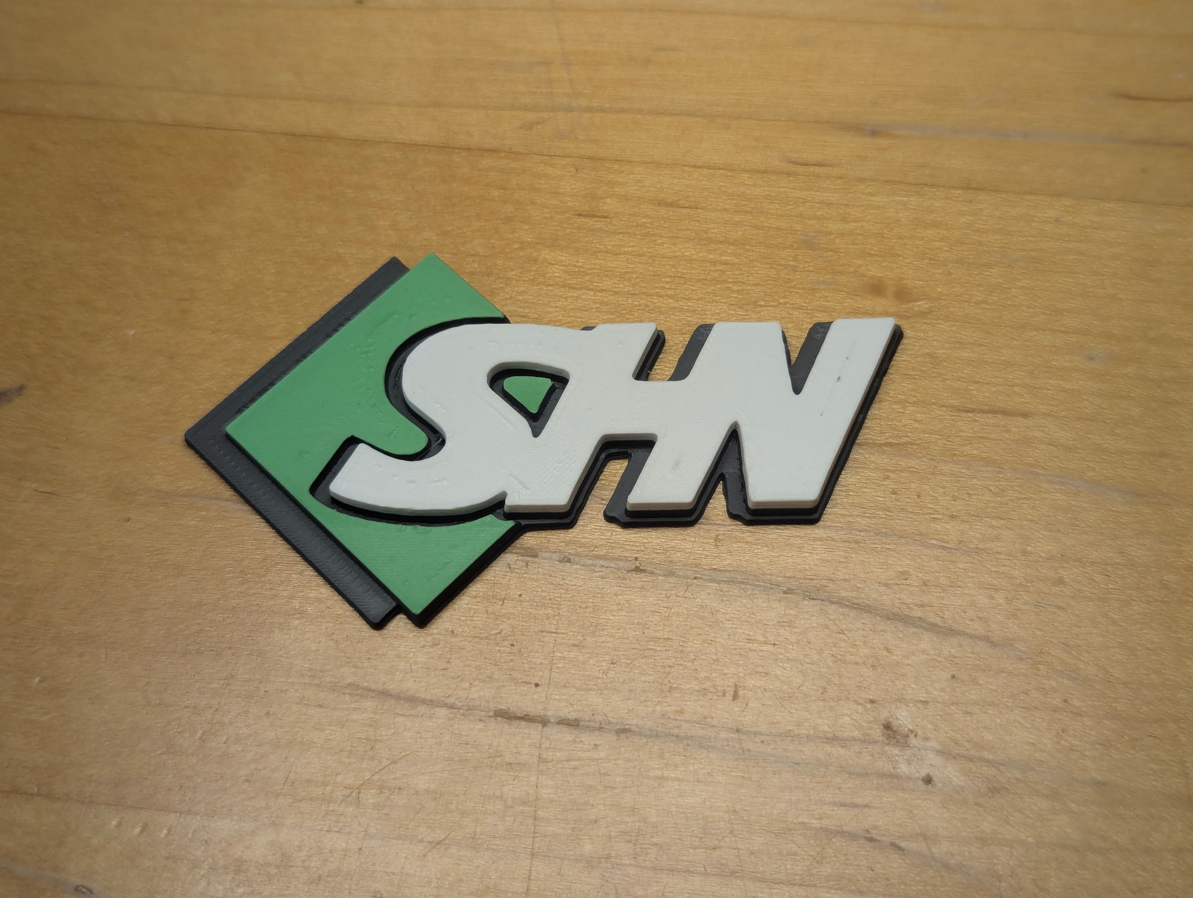 SHN business logo printed in multi-color filament