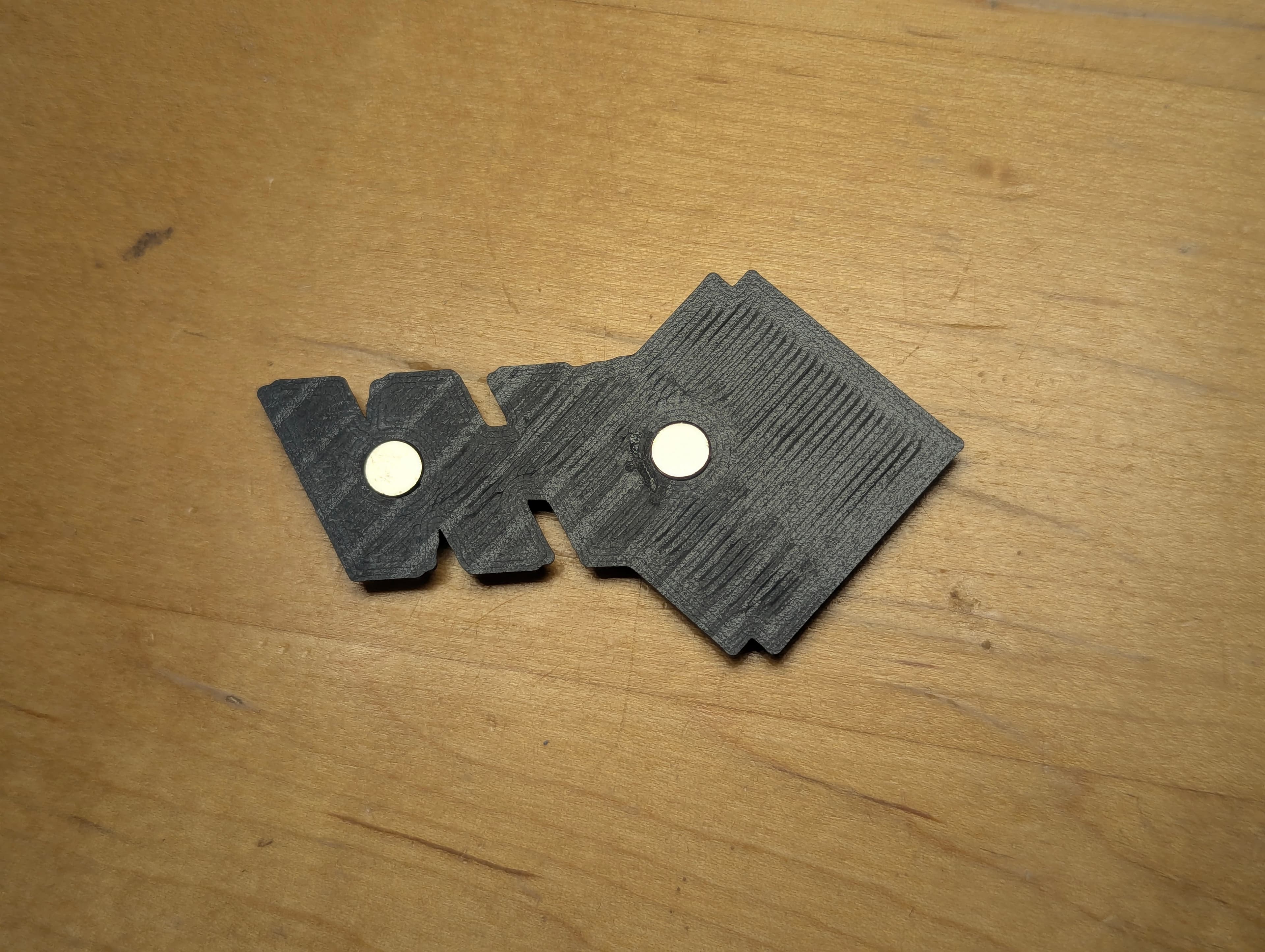 Back of logo prints showing embedded magnets